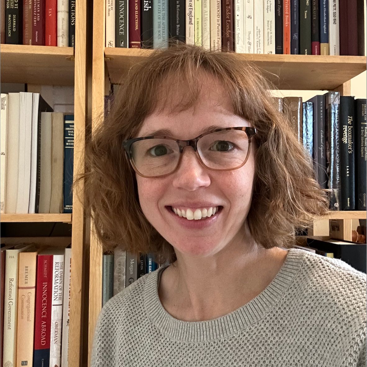 Headshot of Amy G. Tan in front of a bookshelf